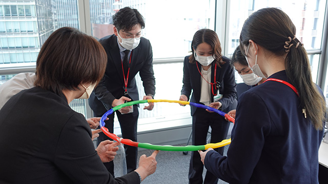 photograph:Lowering the hula hoop while calling out to each other