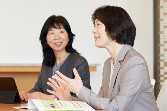Photo: A woman talking and a woman listening attentively